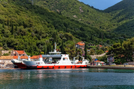 Ferry transports tourists and cars from Lepetane - Kamenari at Bay of Kotor, Montenegro.のeditorial素材