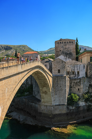 Tourists stroll across the Old Bridge in Mostar, Bosnia and Herzegovina.のeditorial素材