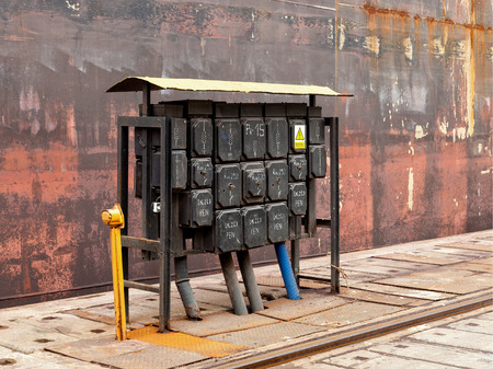 Electrical equipment at a switching board in shipyard.