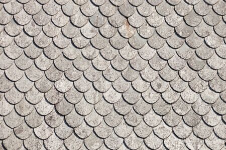 Close up detail of the abstract patterns made by old grey roof tiles.の写真素材