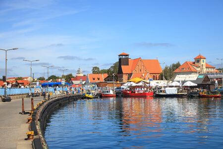 People walking through in the port on the waterfront with many boat on August 10, 2015 in Hel, Poland.のeditorial素材
