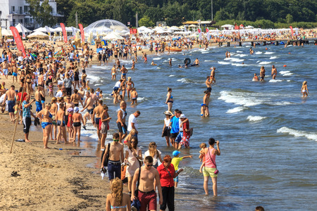 Sandy beach scene of many people suntanning, relaxing and enjoying the shore in summer day on August 9, 2015 in Sopot, Poland.のeditorial素材