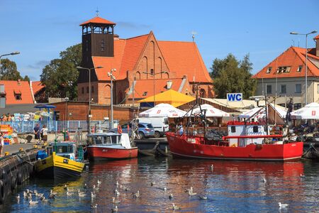 People walking through in the port on the waterfront with many boat on August 10, 2015 in Hel, Poland.のeditorial素材