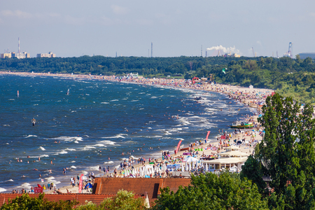 Sandy beach scene of many people suntanning, relaxing and enjoying the shore in summer day on August 9, 2015 in Sopot, Poland.のeditorial素材