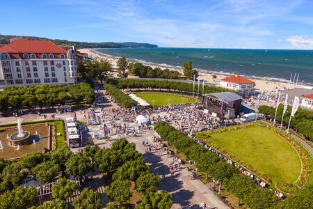 Crowd of people walking on square near wooden pier in the distance, on August 09, 2015 in Sopot, Poland.のeditorial素材