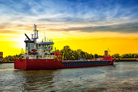 Floating cargo ship in port of Gdansk, Poland.の写真素材