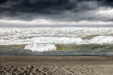 Stormy dark clouds in the sky over rough sea.の写真素材