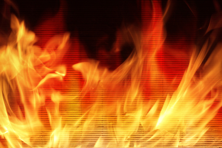 Wooden wall on fire with flames - Fire safety concept.