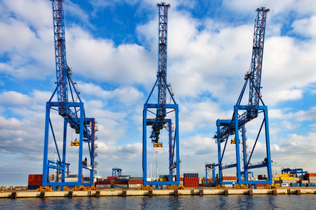 A large crane used for loading containers on cargo ships.の写真素材