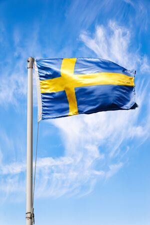 The Sweden national flag flying in the wind.の写真素材
