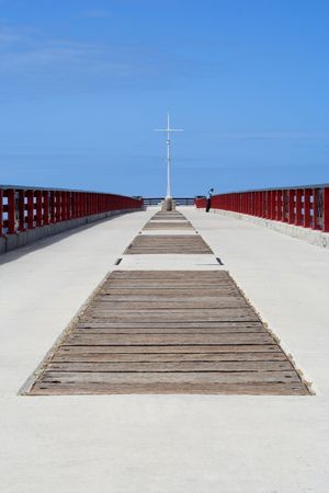 Lonly lady standing at the end of a pierの写真素材