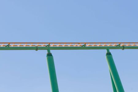 Rollercoaster track against a brilliant blue sky