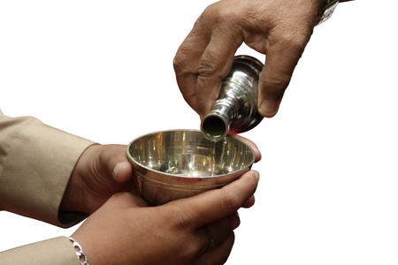 the kin is pouring water onto the brass vessel for the dead might benefit from meritmaking in...