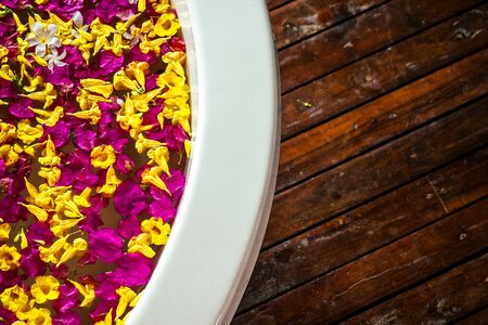 copyspace interior top view bathroom bali eco hotel luxury suite.bath with tropical flowers rose...
