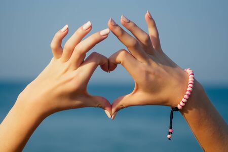 heart shape with hands on sunset Goa India.の写真素材