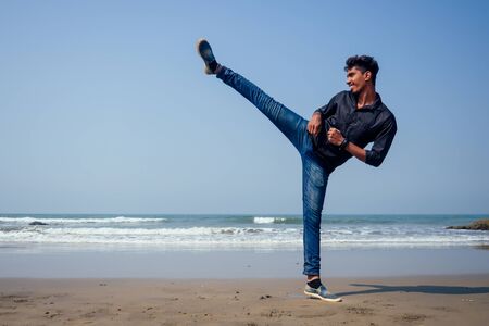 training taekwondo of the two young indian men on the Goa beachの写真素材