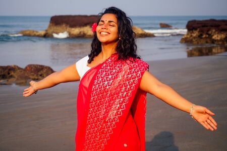 portrait of attractive indian female model in vacation on paradise tropical beach by ocean sea....