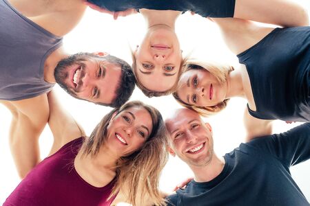 a happy group of people from men and women practicing yoga in the studio. groups of meditation ,...