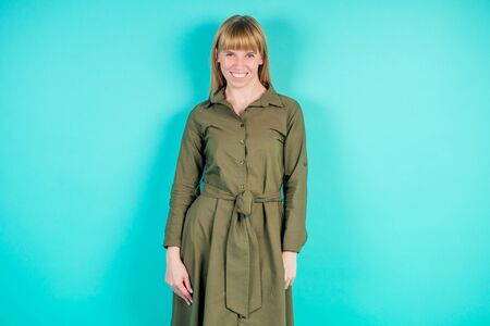 blonde woman in studio on blue backgroundの写真素材