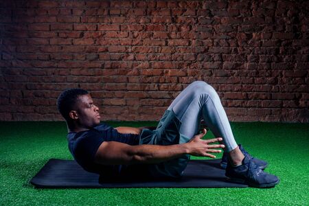 athlete in the gym doing exercises for abdominal abc muscles