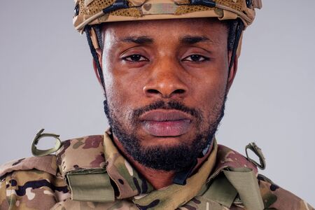 military army african male camouflage suit sorrow white background studioの写真素材