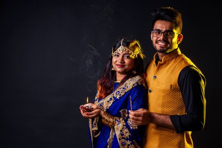 indian female and hindu man celebration divali studio background