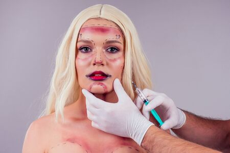 beauty injection in the blonde female face studio backgroundの写真素材