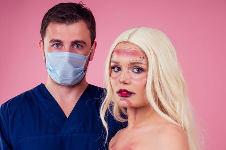 portrait young fashion victim blonde  woman perfect halloween make up face draw line and big red lips with silicone breast implants.plastic surgery addiction afraid to be yourself conceptの写真素材