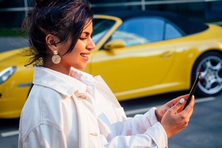 beautiful india girl making selfie on the background of the business center Moscow sity and yellow...