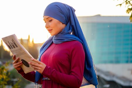 Muslim successful business woman well-dressed in park street autumn forest treesの写真素材