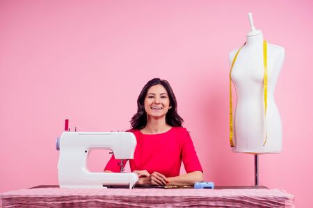 sewing pattern,sewing machine and maniken in studio pink background.seamstress curve template....