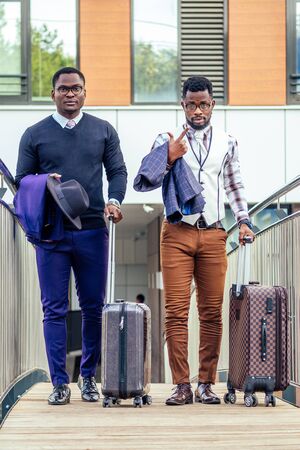 Afro american man well dressed and successful african businessman walking train at railway station bus station. a trip to a business meeting in the capital to business partners waiting for a flightの写真素材