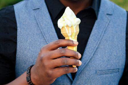 close-up hands of black men in stylish suits a meeting in a summer park. African-Americans friends...