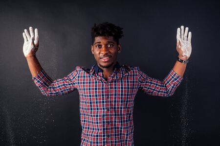 Drunk African American Afro businessman sloppy man with dreadlocks hands up soiled in white powder...