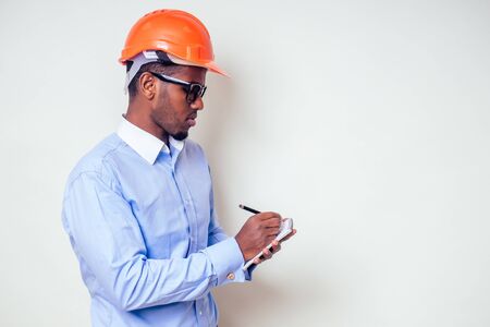 architect designer black man African American holding paper drawing template.happy african builder...