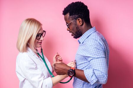 Portrait of a smiling female doctor with afro american patient man.beautiful blonde woman white...