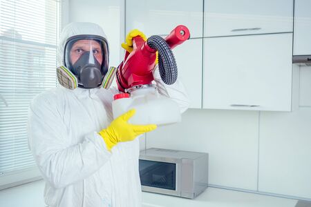 white worker spraying pesticide on induction hobの写真素材