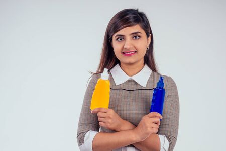 indian woman holding bottle of sun cream in studio white background