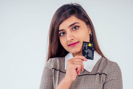 happy indian girl holding credit card in studio white background