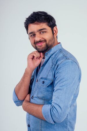 Adult hispanic man over isolated white background happy face smiling wearind denim jacket jeans...