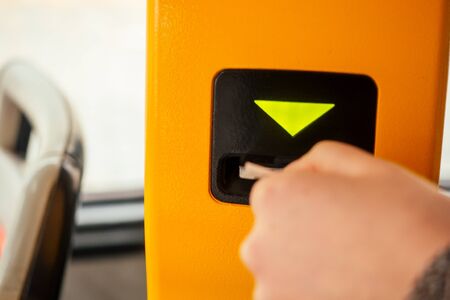 Young woman hand inserts the bus ticket into the validator, validating and ticking in Prague sity Chezh.の写真素材