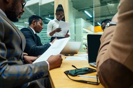 Asian business person in multiracial. Diversity business people form by different races, Indian, Malay, Indonesian, Chinese and African in modern room shopping mallの写真素材