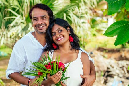 indian male making proposal with engagement ring and roses to his girlfriend at sea beach.Valentine day at Goaの写真素材