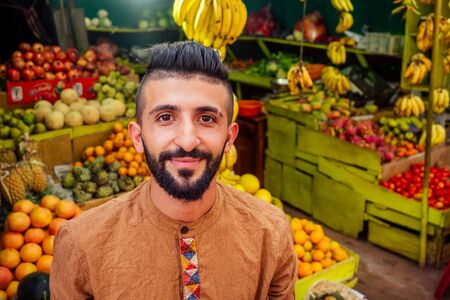 arabian man offering a pineapple on the street in goa