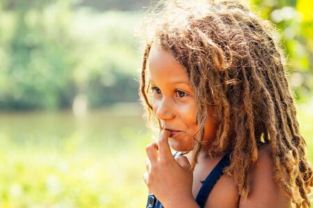 Mowgli indian boy with dreadlocks hair in tropics green forest backgroundの写真素材