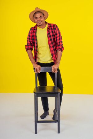 arabic brazilian man posing at studio in yellow backgroundの写真素材