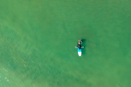 surf instructor and woman learning extreme water sport in Goa