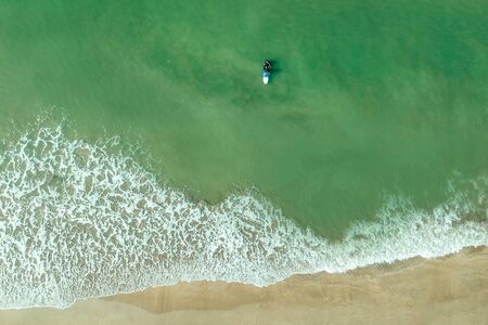 surf instructor and woman learning extreme water sport in Goa