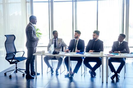 boss afro businessmen talking with arab partners colleague, multiethnic team in the office with...