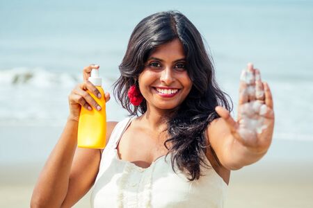 portrait of a beautiful and smiling snow-white smile indian woman black curly hair and dark skin in...